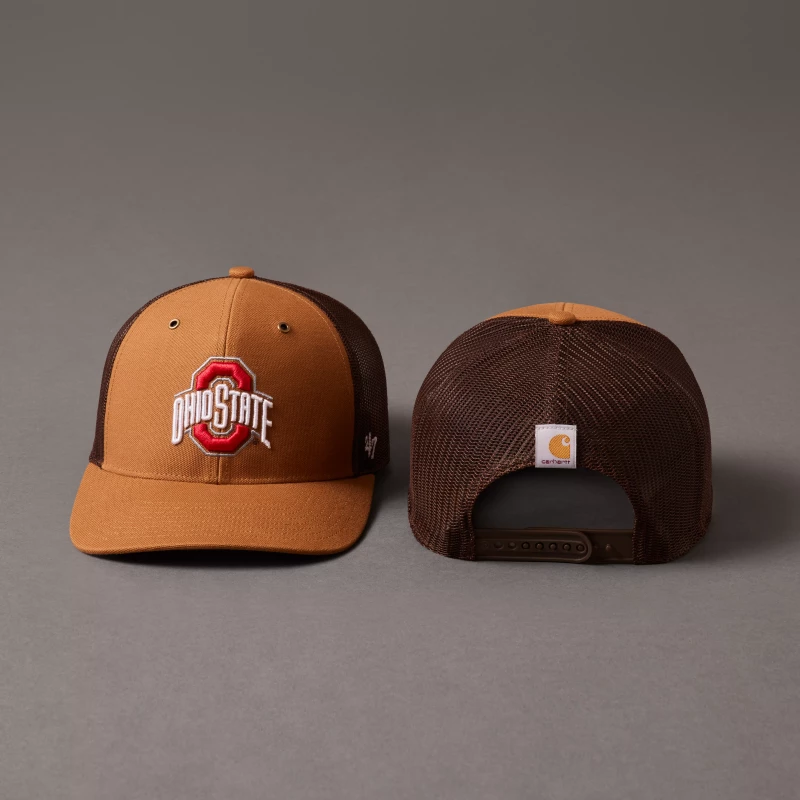 the front and back of a '47 x carhartt hat sit side by side on a gray studio background. the hat is carhartt's signature duck brown color with a dark brown mesh back. an Ohio State logo in on the front of the hat.